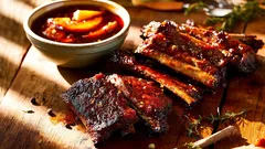 Give classic barbecue a bold twist with smoky peach bourbon sauce