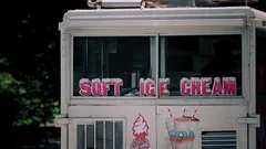 White and red Coca-Cola branded ice cream truck on street
